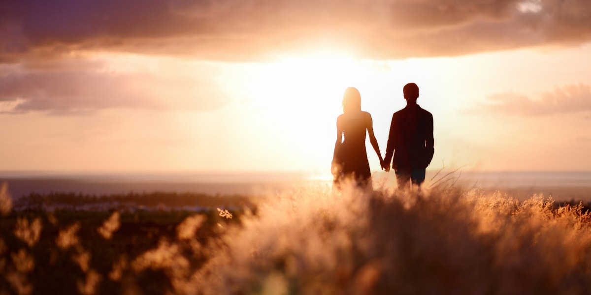 A couple standing together with abstract number motifs.